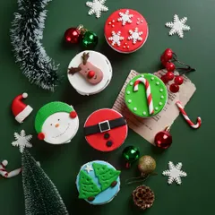 I love getting creative for the holidays. These are some of our hand-decorated Christmas cupcakes, featuring fun designs like Santa's belt, reindeer, and snowmen, all completely eggless and made from scratch.