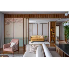 A living room in the 'Ikigai House' featuring a hand-painted mural on the wall panels. This collaboration with a Thangka artist turns the architecture itself into a canvas, embedding art directly into the fabric of the home.
