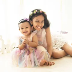 Double the giggles, double the grins! There is nothing sweeter than the bond between sisters. Capturing these two smiling together was a moment of pure joy.