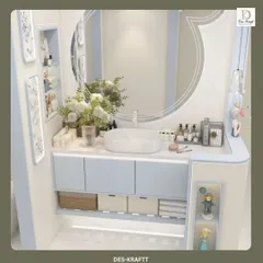 The vanity area is designed for maximum utility, with a mix of open and closed storage in a soft blue finish, complemented by a large, uniquely shaped mirror.