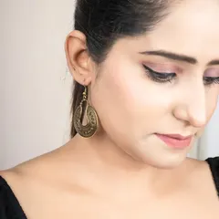 A close-up shot focusing on a pair of antique-finish earrings. I ensure the lighting perfectly captures the texture and detail of the jewellery.