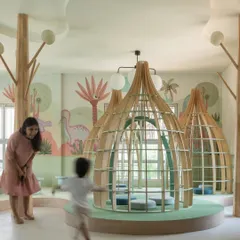 A moment of pure joy in the nursery library. The custom-designed reading pods, shaped like gentle huts, create a sense of privacy and magic, encouraging children to get lost in a book.
