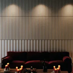 This living space features our concrete fluted walls. The vertical lines create an illusion of height and rhythm, while the spotlights highlight the texture, turning a simple wall into a sophisticated architectural feature.