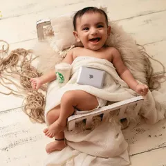 The future CEO. This fun and creative newborn setup with a tiny laptop and coffee cup is a playful take on modern life.