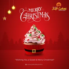 A festive Christmas cupcake designed to look like Santa's suit, complete with a black belt and buckle, topped with pink frosting and holiday sprinkles.