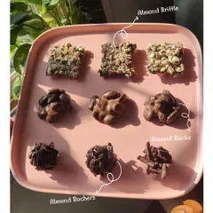 Can you pick a favourite? This platter showcases three of my signature chocolate nut clusters: Almond Brittle, Almond Rocks, and Almond Rochers. Each offers a unique crunchy and chocolatey experience.