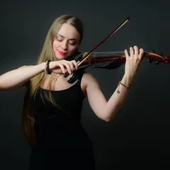 A portrait of a musician lost in her art. Capturing these moments of intense focus and passion is what makes a personality portrait truly special.