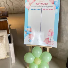 Another fun game for a baby shower, this board invites guests to suggest baby names. The cute design and pastel balloon flower make it a lovely addition to the party decor.