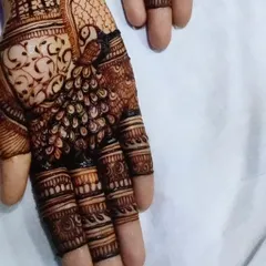 A close-up of the peacock motif on the palm, a symbol of grace and beauty, which is a perfect complement to the bridal portraits.