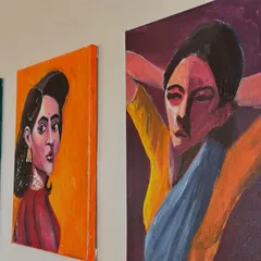 A series of my acrylic portrait paintings displayed on a wall. The theme for this collection was capturing women in a moment of quiet rest and self-care, using bold colours and expressive brushstrokes.