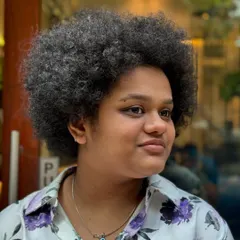 This client came to me with her gorgeous, full afro, ready for a change. This is the "before" shot, showing the hair's natural volume and texture that we worked with.