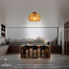 A large, textured amber glass pendant makes a bold statement over this kitchen island. It is more than just light; it's a declaration of luxury and sophisticated taste in the heart of the home.