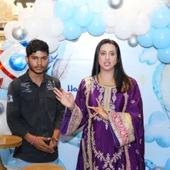 Actress Sanjjanaa Galrani speaking during her son's birthday party, with our blue and white balloon backdrop behind her. It's always a pleasure to work with such wonderful clients.