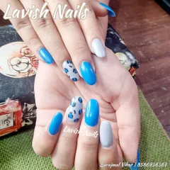 A fun and trendy set combining bright blue, grey, and a playful blue leopard print accent nail.