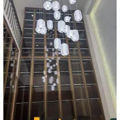 A shot looking up at the stunning, multi-story cascading light fixture in the Defence Colony law office. This feature piece was designed to create a sense of awe and modern elegance.