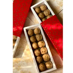 Our Atta Panjiri laddoos packed in elegant red and white drawer-style boxes. The packaging is designed to be both beautiful and sturdy for gifting.