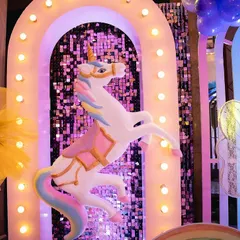 This prancing unicorn prop was a highlight of the party. We mounted it on a lit-up arch with a sequin backdrop to create a magical photo opportunity.