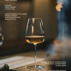 A single glass of white wine from our extensive list. This image highlights some of our selections, including a German Gewürztraminer, an Italian Pinot Grigio, and a French Sauvignon Blanc.
