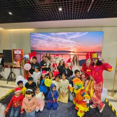 A happy group photo on stage with our performers and young guests. Our clowns, jugglers, and Santa Claus love posing for pictures to help families capture the fun memories from the event.
