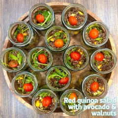 Our Red Quinoa Salad with avocado and walnuts, served in individual jars. This wholesome and convenient option is packed with protein and nutrients.