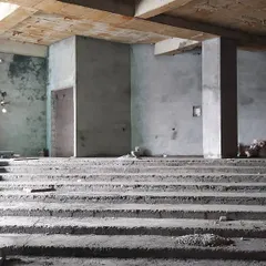 This image shows the early stages of an auditorium we are constructing within the Maulana Azad Bhavan. Here you can see the bare concrete structure and tiered seating arrangement before the acoustic panels and finishing materials are installed.