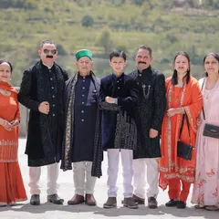 A formal family portrait from a beautiful Himachali wedding, capturing multiple generations dressed in their traditional best.
