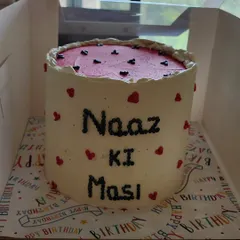 A tall vanilla cake with layers of apple cinnamon filling and caramel. This was a special order for an aunt, with a custom message piped on the side to make her feel loved.