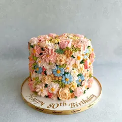 This cake was a special request for an 80th birthday, and the client wanted it completely covered in buttercream flowers. Despite the hot Bangalore weather, we made it work, and the result was this beautiful, textured floral masterpiece.