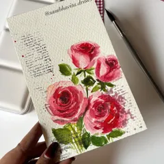 A hand holding one of my watercolor rose postcards. The combination of the painted flowers and the script in the background gives it a lovely, nostalgic feel.