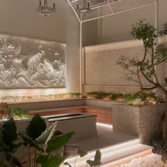 In this indoor courtyard, we used integrated LED strip lighting under the benches and uplighting on the feature wall to create a warm, inviting glow.