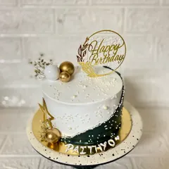 Black or white? Why not both? This striking butterscotch cake features a half-and-half design, accented with gold and white spheres for a modern, elegant look.