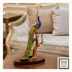 The intricate detailing and vibrant colors of this peacock sculpture make it a true conversation starter. Placed on a coffee table, it brings a touch of artistry and elegance to your living room.
