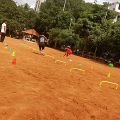 An overhead view of our agility circuit on the dirt field. Athletes navigate through hurdles and cones to develop coordination and the ability to change direction in a split second, a key skill for any competitive sport.