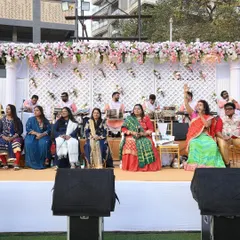 A live musical ensemble performing on stage during a daytime wedding event, creating a beautiful and traditional ambiance.