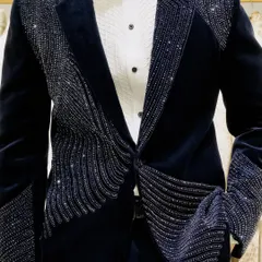 It's all about the details. This close-up shows the precise, handcrafted beadwork on one of our signature velvet reception blazers, designed to catch the light and everyone's attention.
