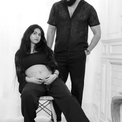 A modern and stylish black and white couple's portrait. The pose is relaxed yet connected, showcasing their partnership on this incredible journey.
