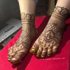 Another angle of the detailed foot mehandi, showing how the design wraps around the sides of the foot. The clean lines and rich paste promise a beautiful stain.