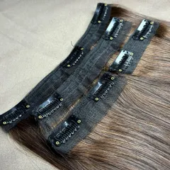 Another detailed view of the premium clip-on wefts. The meticulous stitching ensures the hair is secure, and the lightweight fabric base provides comfort for all-day wear.