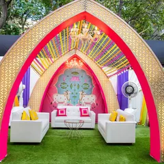 A closer look at one of the seating cabanas from our Pichwai-themed Garba event. The design features a lotus and cow motif backdrop, vibrant pink and purple drapes, and a delicate chandelier, offering a comfortable and picturesque spot for guests.