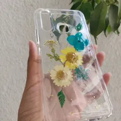 Another view of the floral resin phone case, showing how the clear design allows the phone's color to show through.