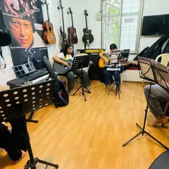 A typical group guitar session at the Gurukul. You can see students at different stages of learning, all focused on their sheet music, creating a collective learning environment where everyone progresses together.