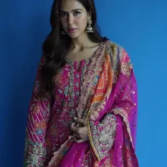 A mid-shot that allows a closer look at the stunning, multi-colored embroidery on the kameez and the delicate tassels on the dupatta. This is traditional craftsmanship at its finest.