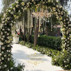 A breathtaking floral archway marks the entrance to this white and gold wedding. We used thousands of white flowers and a hanging crystal chandelier to create a truly magical first impression.