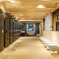 This long-view of the showroom demonstrates how I organize product displays for clarity and impact. The linear arrangement of showerheads and toilets allows for easy comparison, guided by clean sightlines and uniform lighting.
