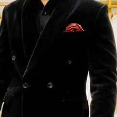 Class is timeless. Our black velvet double-breasted tuxedo is a perfect example, with its sharp peak lapels and a fit that's tailored to perfection. The red pocket square adds a pop of color.