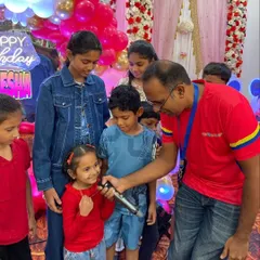 The birthday girl gets her moment on the microphone. We make sure the star of the day feels special, encouraging them to lead and share their excitement with friends.