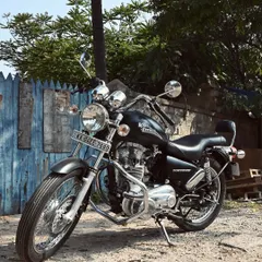 Another angle of the restored Thunderbird, showcasing its classic cruiser lines against a rustic backdrop.