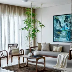 We blend minimalist design with touches of Indian warmth to create homes that are both peaceful and inviting. The traditional wooden swing in this Terrazzo Residence living room adds a sense of playfulness and cultural resonance to the clean, contemporary aesthetic.
