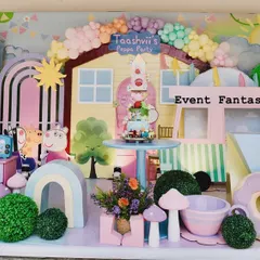 A closer look at the Peppa Pig dessert table, featuring the cake set in front of Peppa's house, surrounded by mushroom props and other fun details.