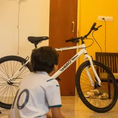 A young tinkerer contemplates the bicycle in front of him before we begin our disassembly session. This is the quiet moment before curiosity takes over and the learning begins.